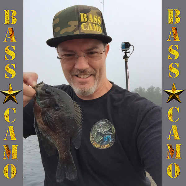 Bass Camo "Back In Black" Fishing Shirt performance short sleeve t-shirt features front and back vibrant design 4.3 oz 100% ring spun cotton for superior softness with set-in baby rib collar and tear away label.